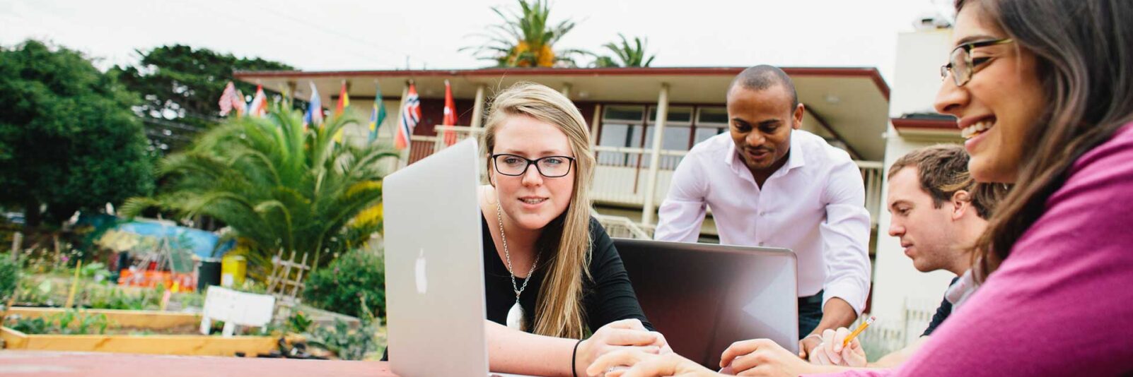 Middlebury Institute students working on a group project on their laptops.